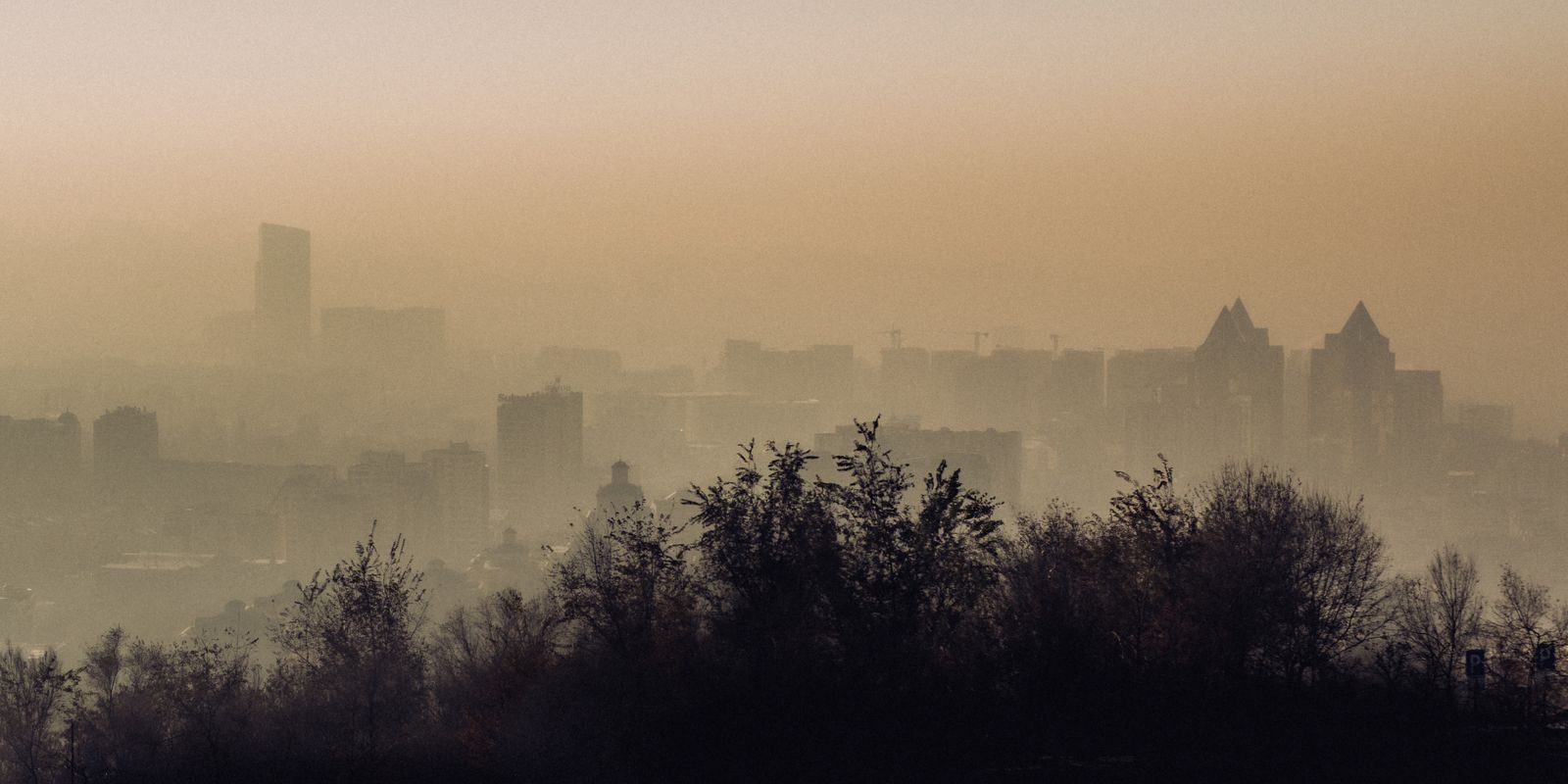 Bookfest Happens Rain, Shine, or SMOKE! Image 1 Atmospheric view of Almaty city skyline enveloped in fog and smog.