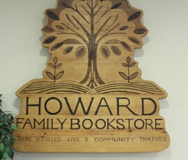 Howard Family Bookstore interior signage in Detroit. Photo ©2025 by Ryan M Place. All rights reserved. Handcrafted wooden sign reading "HOWARD FAMILY BOOKSTORE"